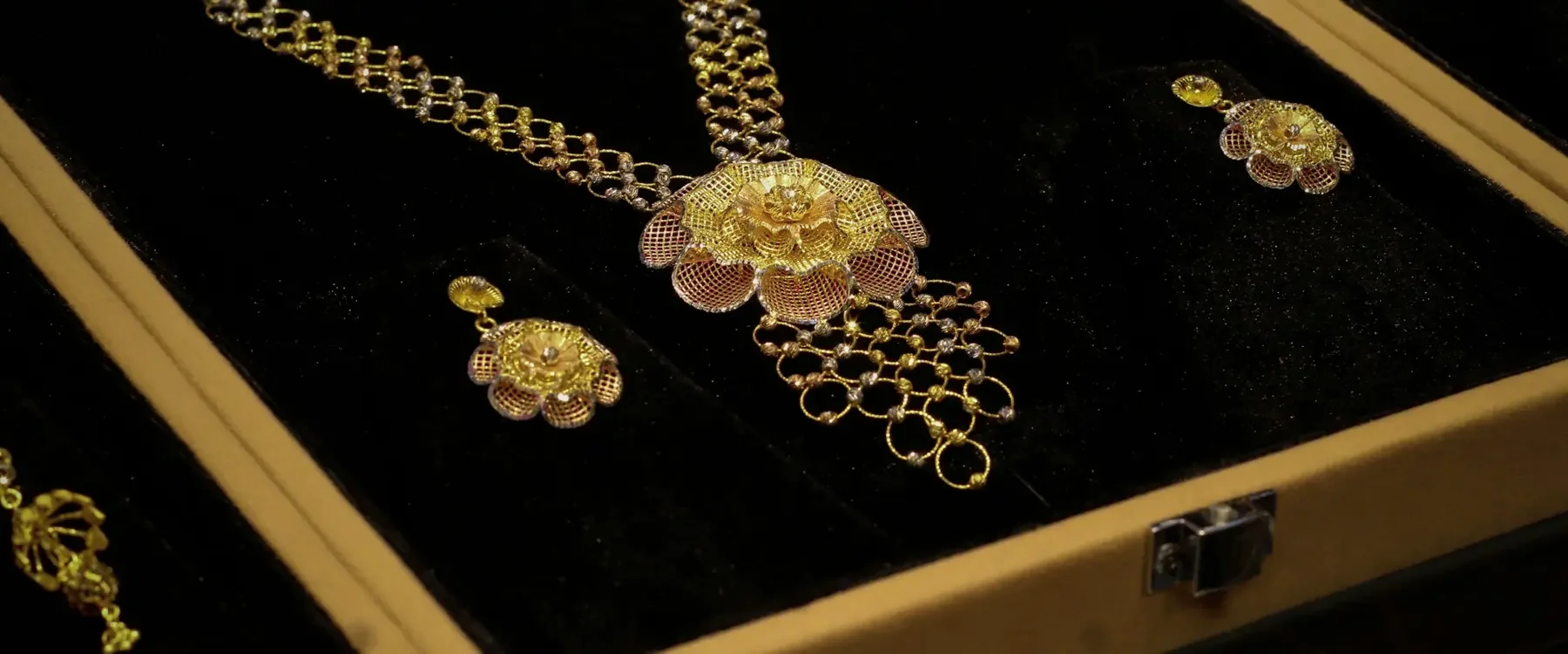 Gold necklace set and earrings in a black velvet display box