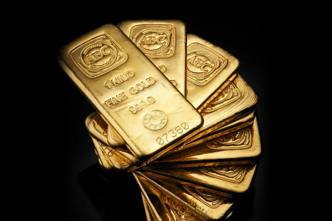 Gold bars on a dark surface